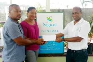 Dominican homeowners Daryl and Anna Lewis are insured with Sagicor General and were among those receiving cash settlements from Sagicor General’s Assistant Vice-President of Claims, John Chandler . 